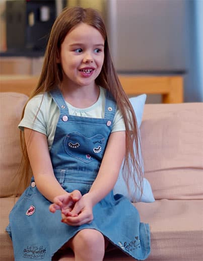 Child seated on couch