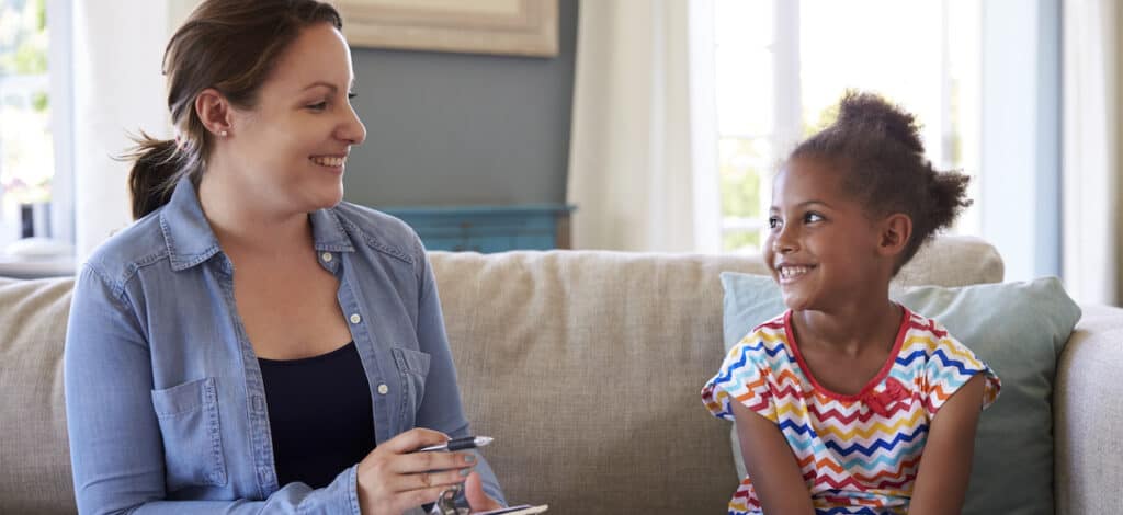 Young girl and MDT member on a couch. 