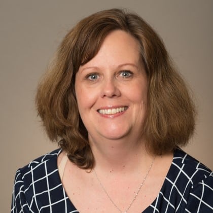 Studio photo of Michelle Miller on a beige background