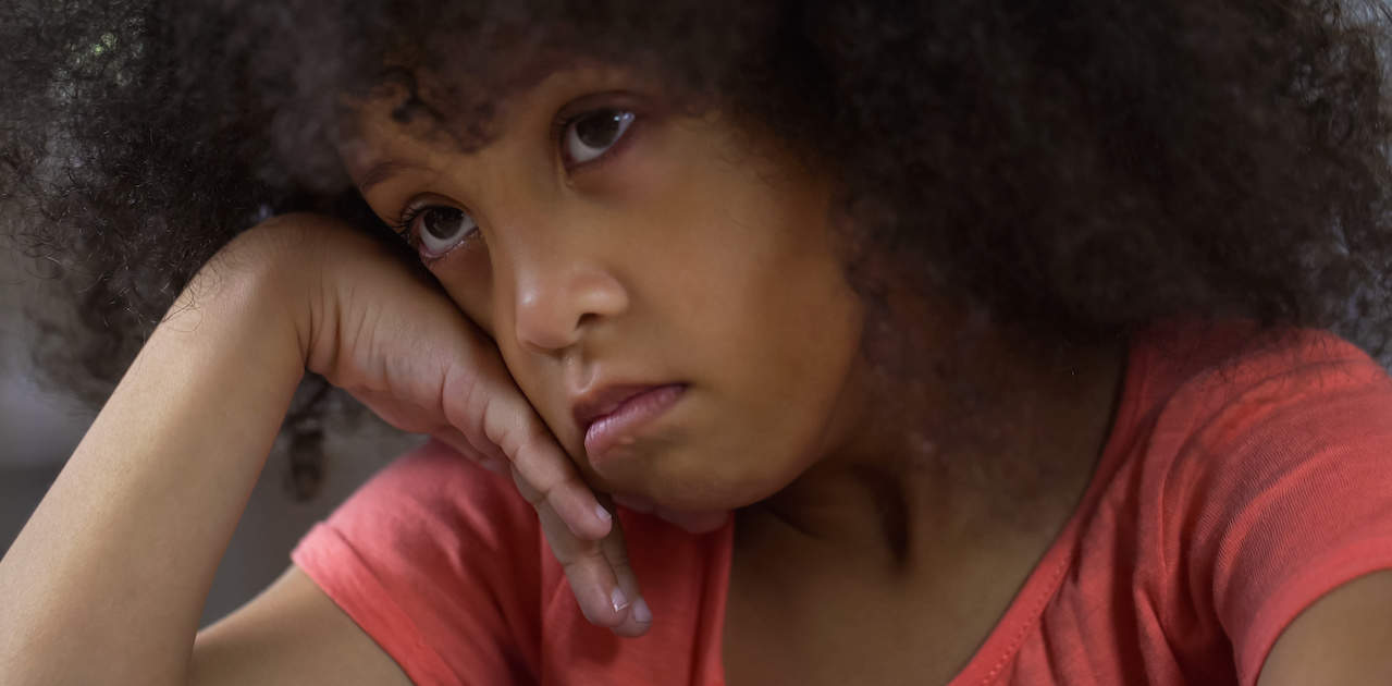 A depressed young girl sitting alone