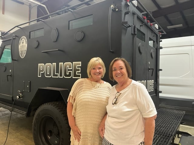 Two NCA site reviewers stand near a police vehicle during site review at Brownsburg Police Department