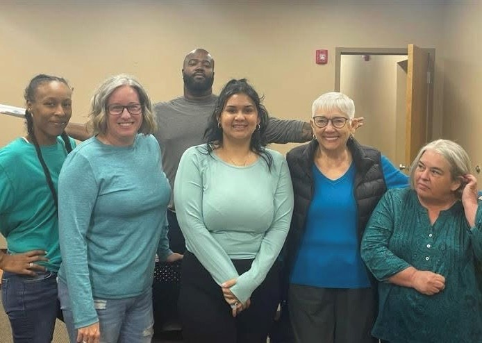 Pat Smallwood poses with staff members